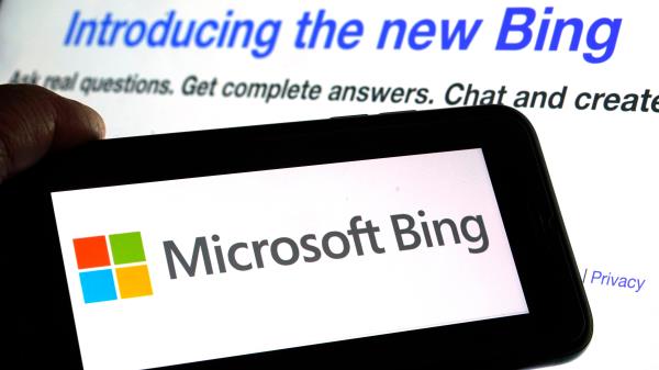 The Microsoft Bing logo and the website's page are shown in this photo taken in New York on Tuesday, Feb. 7, 2023.  Microsoft is ready to take its new Bing chatbot mainstream — less than a week after making major fixes to stop the artificially intelligent search engine from going off the rails. The company said Wednesday, Feb. 22,  it is bringing the new AI technology to its Bing smartphone app, as well as the app for its Edge internet browser.