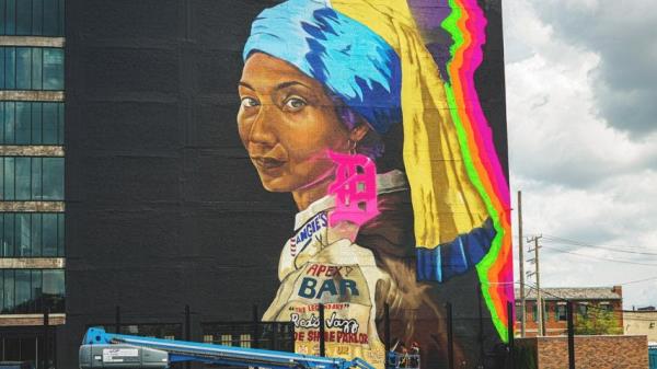 An 8,000-square foot mural of a black women wearing multi-colored scarves and a Detroit-earring on the Chroma office building on Grand Boulevard by Sydney G. James