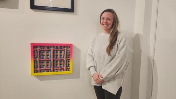 Heather Macali, 38, poses next to her creation on March 2, 2023 at Reyes Finn gallery in Corktown.